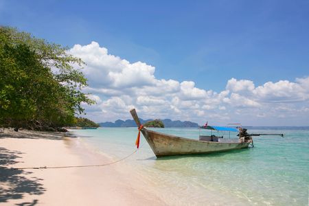 beautiful longtail boat on the sand seashoreの写真素材