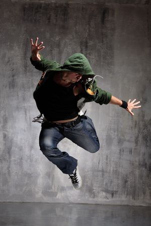 coll looking dancer posing on a grunge grey wall coll looking dancer posing on a grunge grey wall