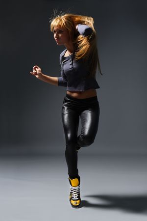 young beautiful dancer posing on greyの写真素材
