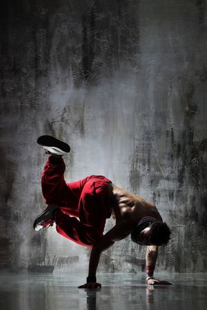 modern style dancer posing on dirty grunge background