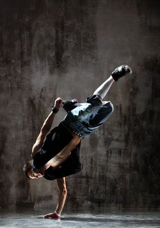 modern style dancer jumping on dirty grunge backgroundの写真素材