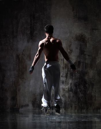 modern style dancer posing on dirty grunge backgroundの写真素材