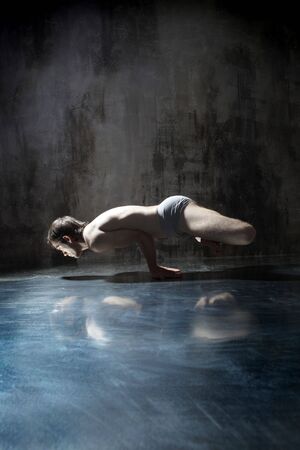 cool yoga man posing on dirty grunge backgroundの写真素材