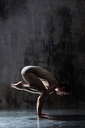 cool yoga man posing on dirty grunge backgroundの写真素材