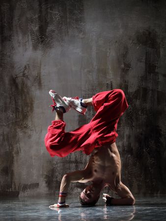 modern style dancer posing on dirty grunge background