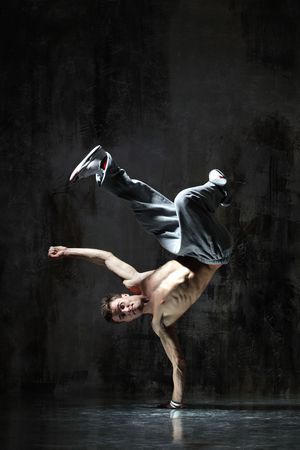 modern style dancer posing on dirty grunge backgroundの写真素材