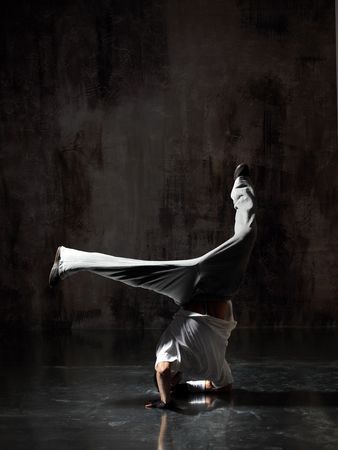 modern style dancer posing on dirty grunge backgroundの写真素材