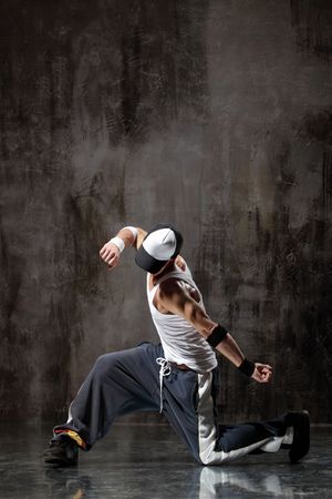 modern style dancer posing on dirty grunge backgroundの写真素材