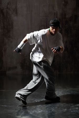 modern style dancer posing on dirty grunge backgroundの写真素材