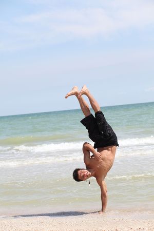 beautiful dancer posing on the sandy sea beachの写真素材