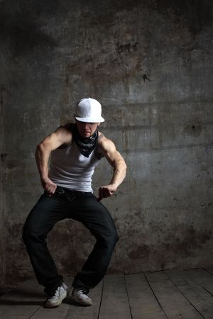 modern dancer poses in front of the studio backgroundの写真素材