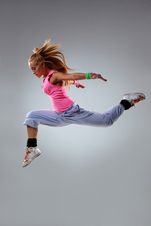 young and beautiful dancer posing on studio backgroundの写真素材