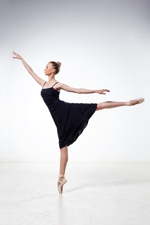 young and beautiful dancer posing on studio backgroundの写真素材