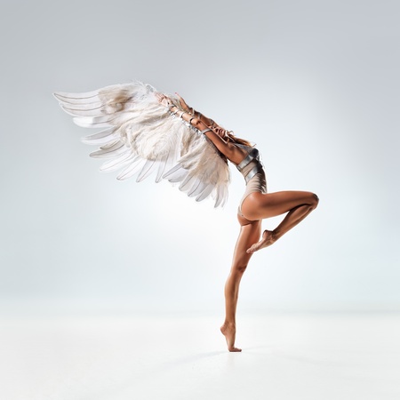 young and beautiful dancer posing in studioの写真素材