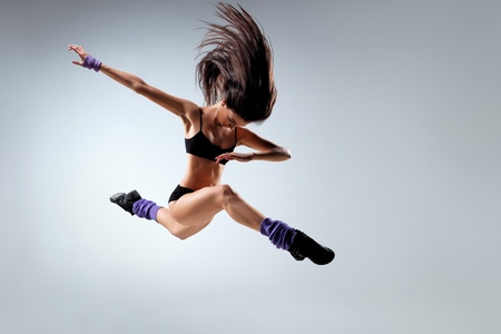 young and beautiful dancer posing on studio backgroundの写真素材