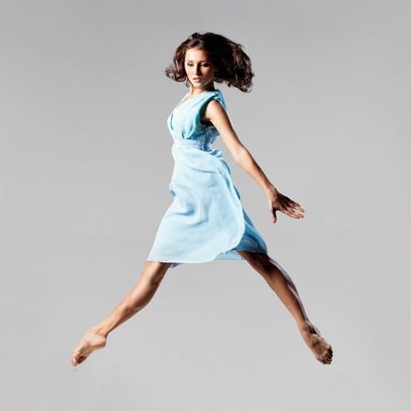 young and beautiful dancer posing on studio backgroundの写真素材