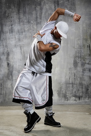 young and beautiful dancer posing on studio backgroundの写真素材