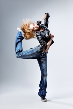 young beautiful dancer posing on a studio backgroundの写真素材