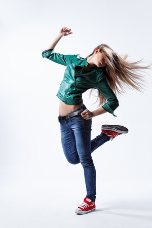 young beautiful dancer posing on a studio backgroundの写真素材