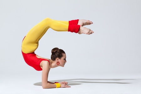 young beautiful dancer posing on a studio background