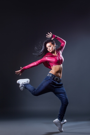 young beautiful dancer posing on a studio backgroundの写真素材