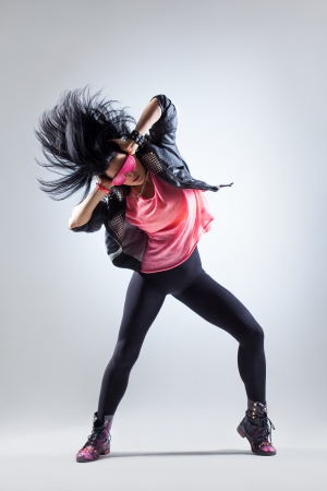 young beautiful dancer posing on a studio backgroundの写真素材