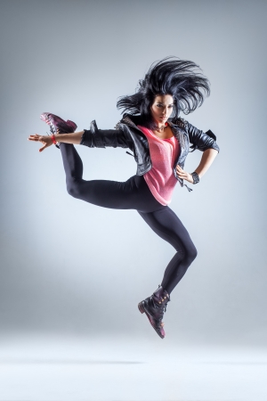 young beautiful dancer posing on a studio backgroundの写真素材