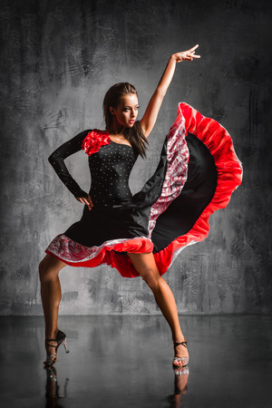 young beautiful dancer posing on studio backgroundの写真素材