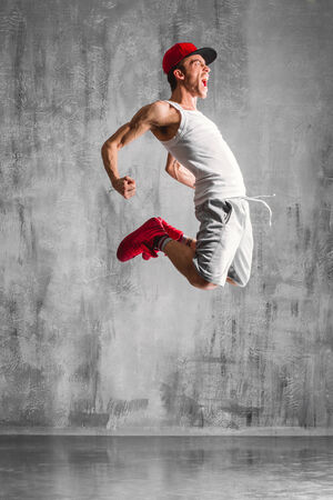 young beautiful dancer posing on studio backgroundの写真素材