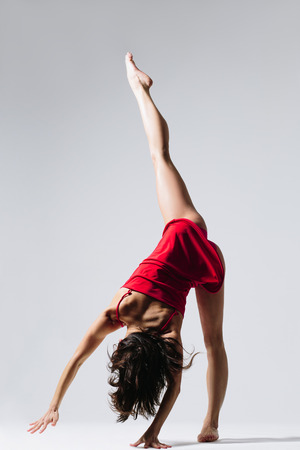 young beautiful dancer posing on studio backgroundの写真素材