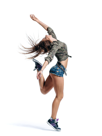 young beautiful modern style dancer posing on a studio backgroundの写真素材