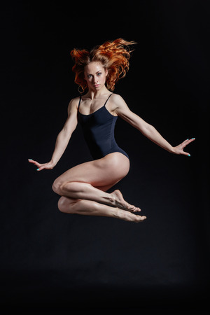 Young beautiful dancer posing in studioの写真素材