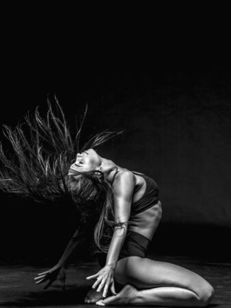 Young beautiful dancer posing in studioの写真素材