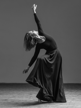 Young beautiful dancer posing in studioの写真素材
