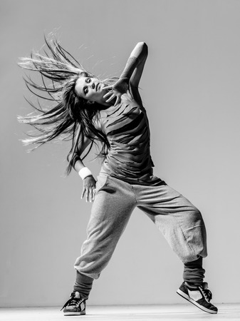 Young beautiful dancer posing in studioの写真素材
