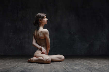 Young beautiful fitness female posing in studioの写真素材