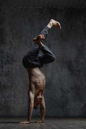 Young beautiful dancer is posing in studioの写真素材