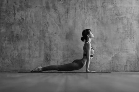 Young beautiful fitness female posing in studioの写真素材