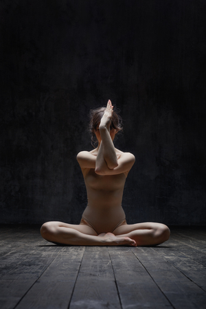 Young beautiful fitness female posing in studioの写真素材