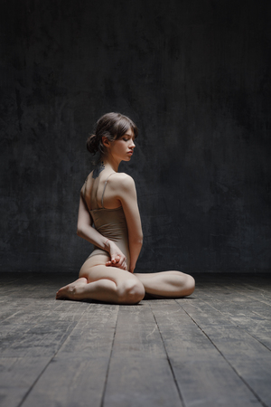 Young beautiful fitness female posing in studioの写真素材