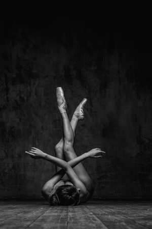 Young beautiful dancer is posing in studioの写真素材