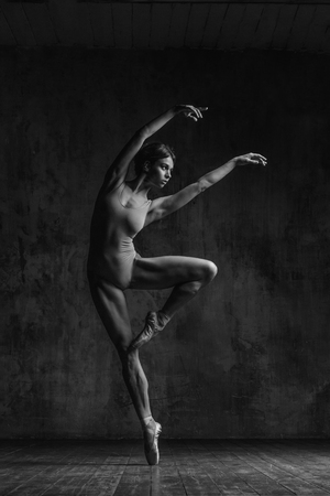 Young beautiful dancer is posing in studioの写真素材