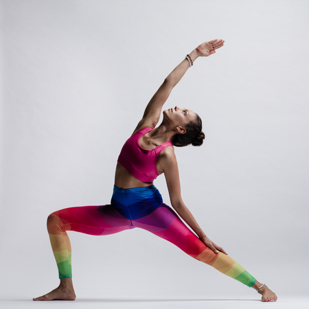 Young beautiful yoga female posing in studioの写真素材