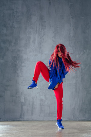 Young beautiful female dancer is posing in the studioの写真素材