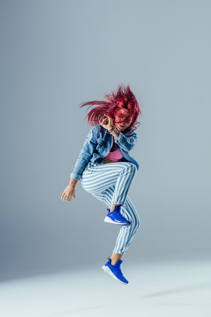 Young beautiful female dancer is posing in the studioの写真素材