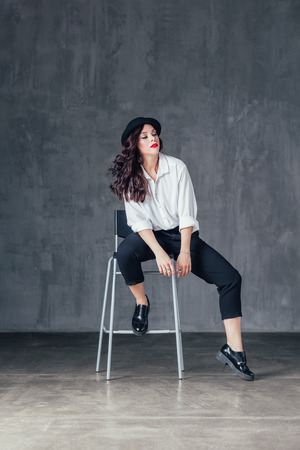 Young beautiful female dancer is posing in the studioの写真素材