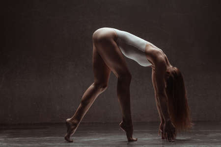 Young yoga woman stretching and training in classの写真素材