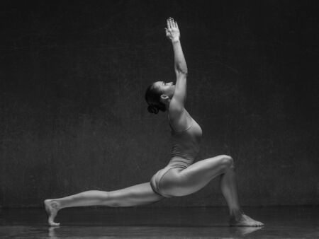 Young yoga woman stretching and training in class