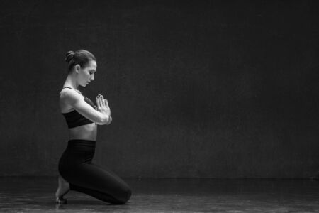 Young yoga woman stretching and training in classの写真素材
