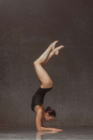 Young yoga woman stretching and training in classの写真素材
